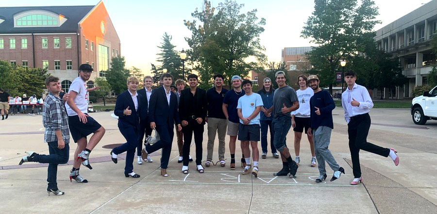fraternity group all wearing high heel shoes